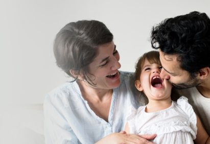 happy-parents-laughing-together-with-daughter